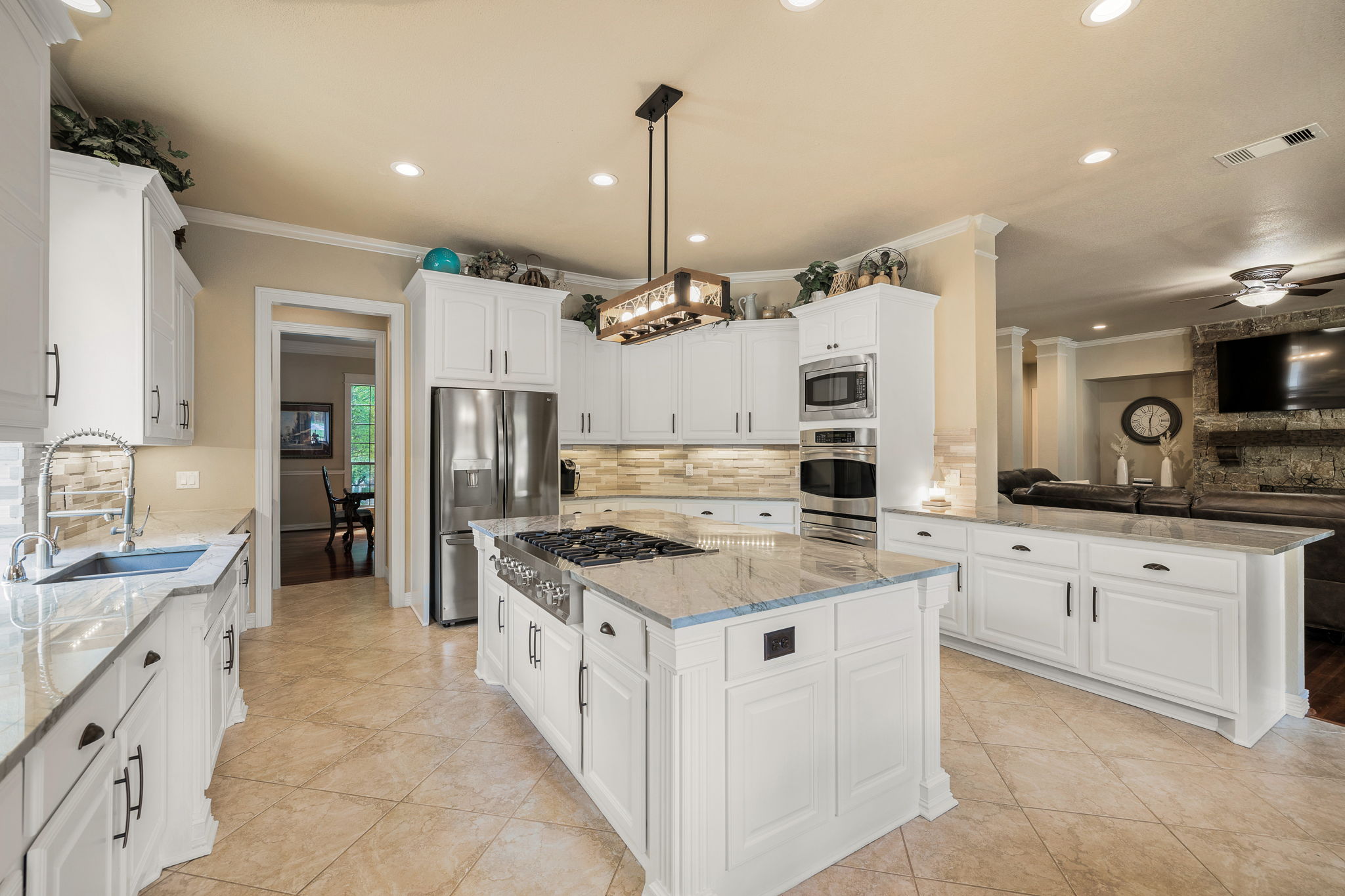 3609 Goodnight Trail Leander, TX 78641 - Photo 10 of 39 a large kitchen with stainless steel appliances granite countertop a stove oven and a white cabinets