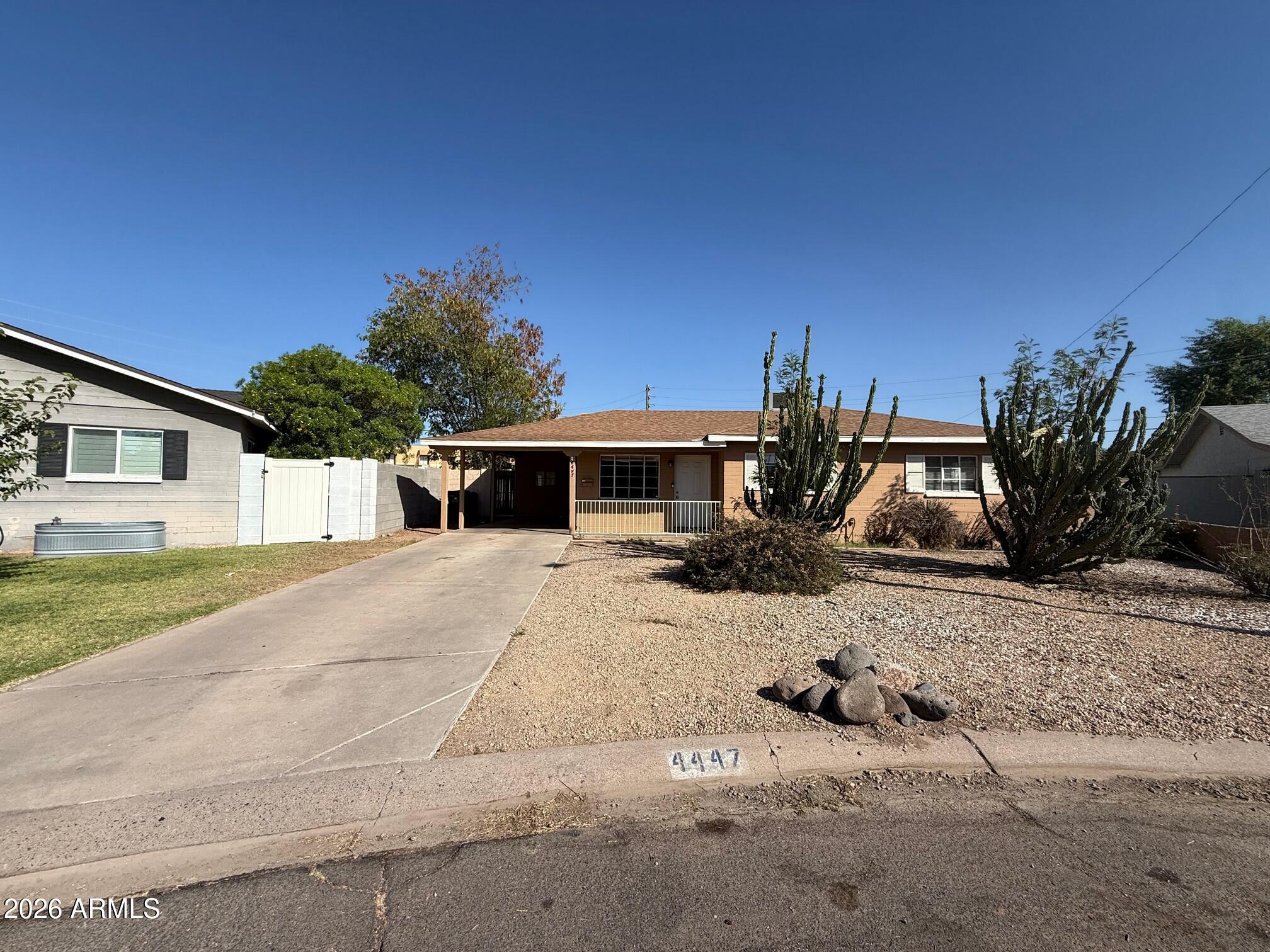 4447 East Almeria Road Phoenix, AZ 85008 - Photo 1 of 9 a front view of a house with garden