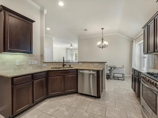 a kitchen with stainless steel appliances granite countertop a sink and stove