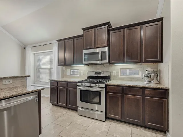 a dining room with wooden floor and a chandelier