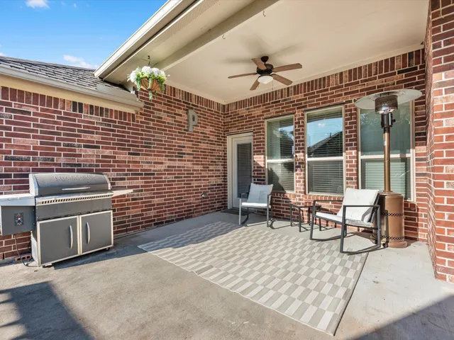 a view of a patio with a table and chairs
