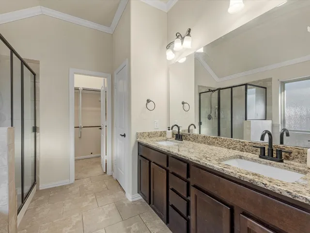 a bathroom with a tub sink shower and mirror