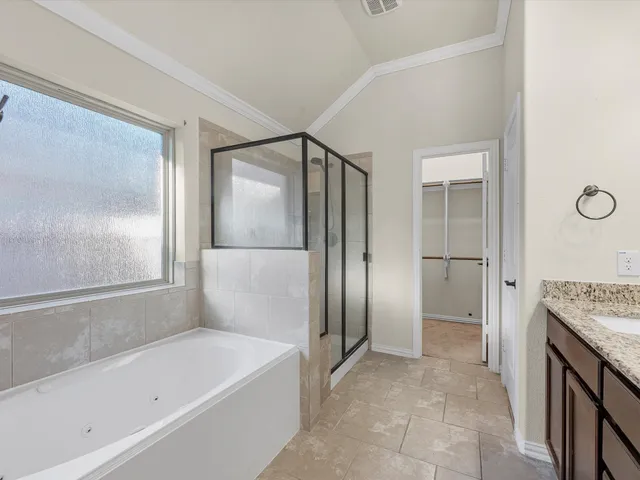 a bathroom with a glass shower door