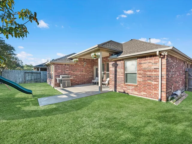 a front view of house with a garden and patio