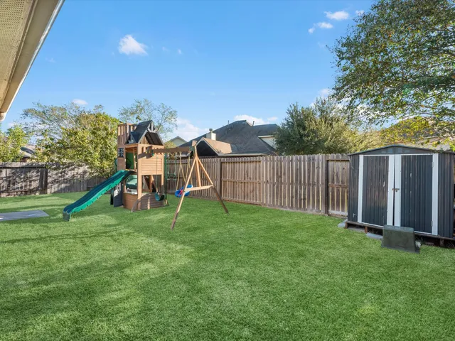 an aerial view of residential houses with outdoor space and swimming pool
