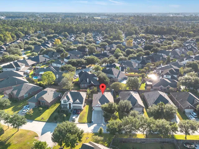 an aerial view of residential building with green space
