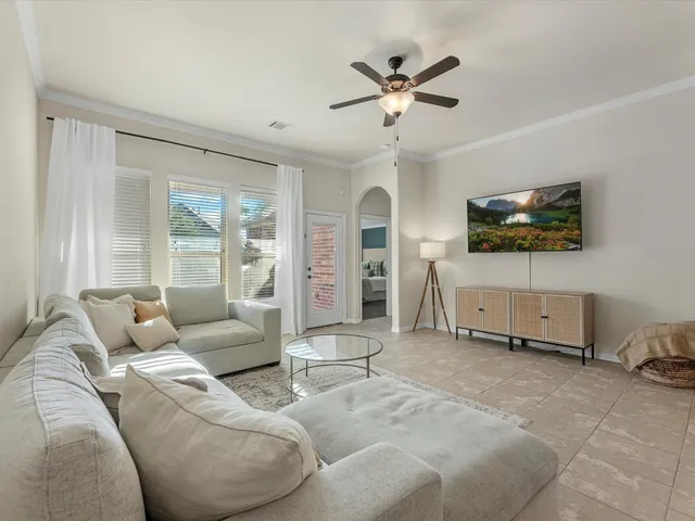 a living room with lots of white furniture