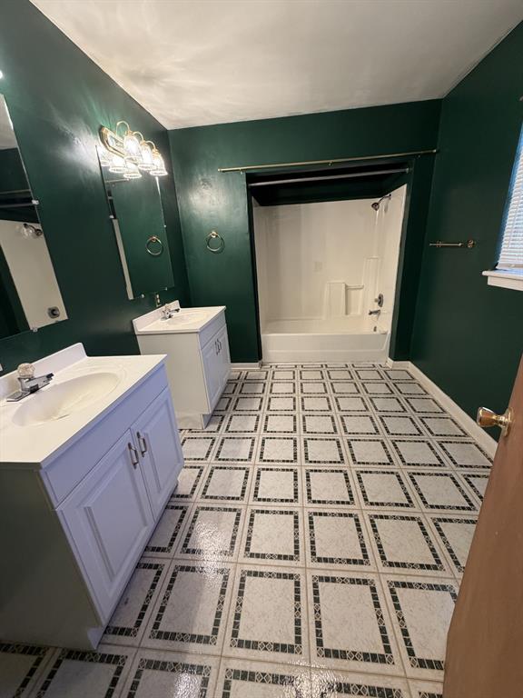 134 Hope Street Mansfield, LA 71052 - Photo 17 of 23 Bathroom 2 featuring wood walls, and light tile patterned floors with dual sinks