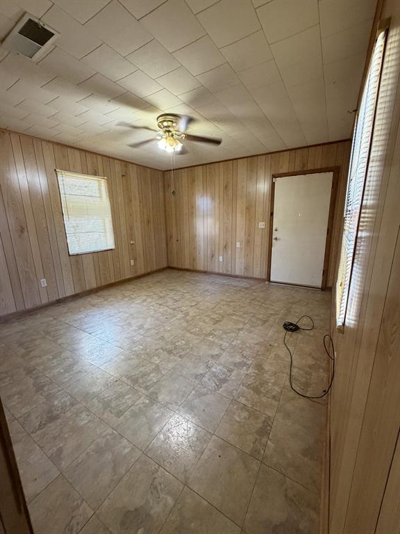 134 Hope Street Mansfield, LA 71052 - Photo 23 of 23 Master bedroom view 2 with wood walls, a ceiling fan, and light floors