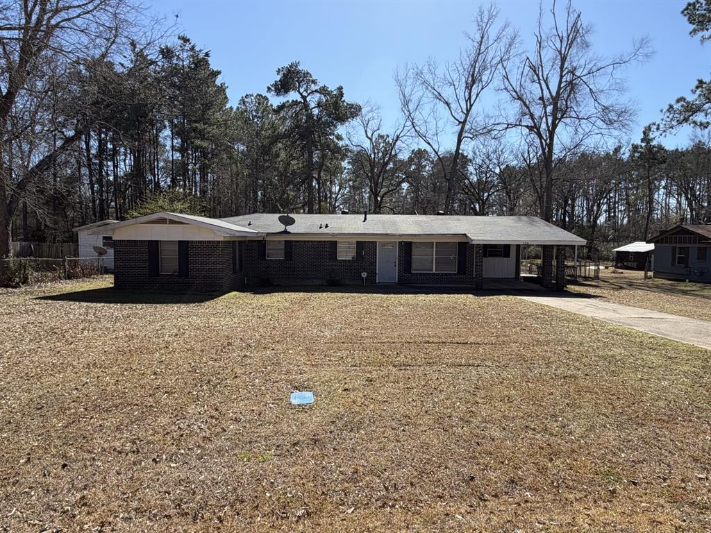 134 Hope Street Mansfield, LA 71052 - Photo 3 of 23 View of front of home featuring concrete driveway, a carport, and brick siding