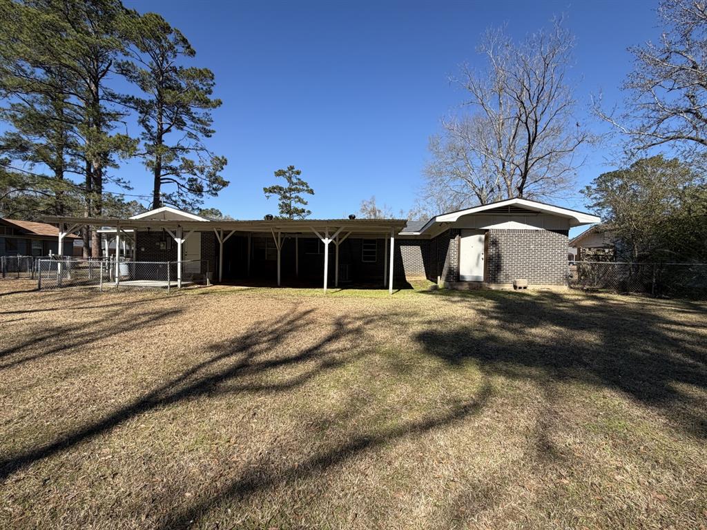 134 Hope Street Mansfield, LA 71052 - Photo 5 of 23 Rear view of house with brick siding and a patio