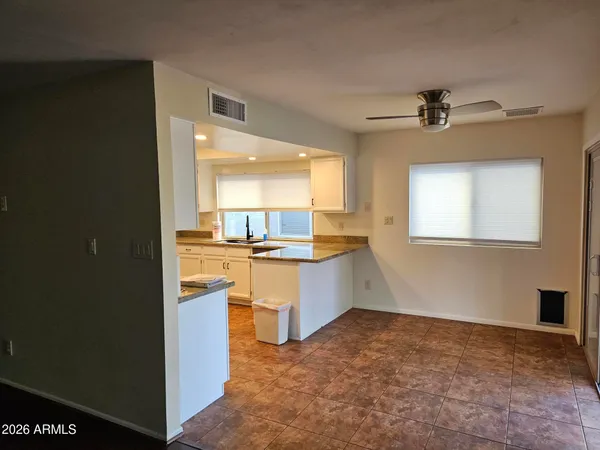 a kitchen with granite countertop a sink cabinets and stainless steel appliances