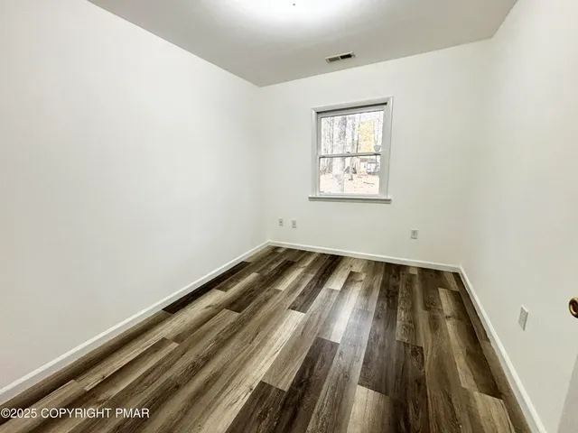 an empty room with wooden floor