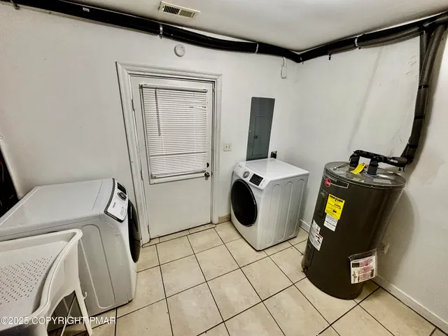 a view of storage and utility room with two washing machine