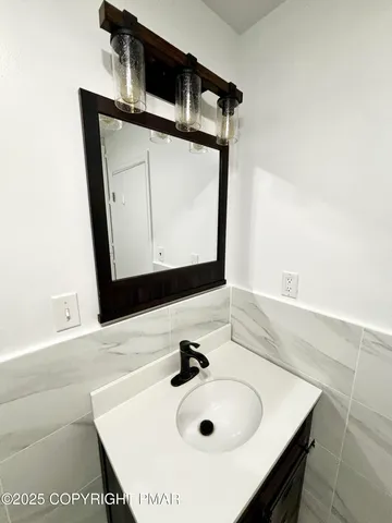 a bathroom with a sink vanity and a mirror
