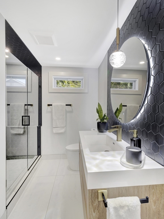 15 Appleton Street Saugus, MA 01906 - Photo 36 of 41 a spacious bathroom with a granite countertop sink a toilet and a mirror