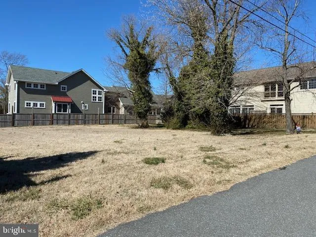 a view of a yard covered with snow in front of house