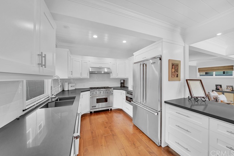119 Via Nice Newport Beach, CA 92663 - Photo 11 of 30 a kitchen with granite countertop a refrigerator a sink a stove top oven a counter space and cabinets