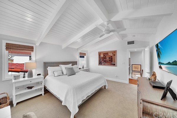 119 Via Nice Newport Beach, CA 92663 - Photo 19 of 30 a bedroom with a bed a couch and a window