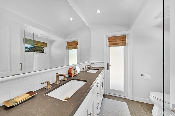 119 Via Nice Newport Beach, CA 92663 - Photo 20 of 30 a bathroom with a double vanity sink toilet and a mirror
