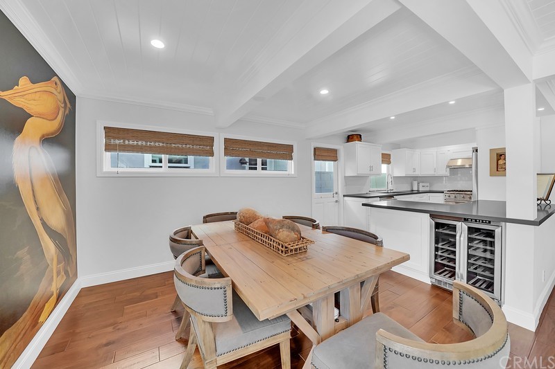 119 Via Nice Newport Beach, CA 92663 - Photo 9 of 30 a kitchen with a table chairs stove and microwave