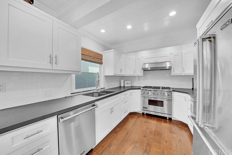 119 Via Nice Newport Beach, CA 92663 - Photo 10 of 30 a kitchen with stainless steel appliances a stove sink and cabinets