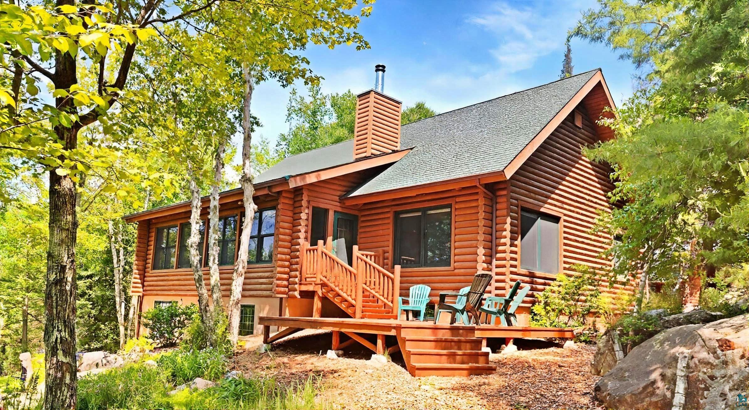 2357 Retreat Lodge Road Cook, MN 55723 - Photo 1 of 60 View of front of property with log exterior, a chimney, a shingled roof, and stairs