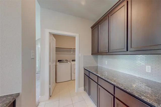 a kitchen with granite countertop white cabinets and stainless steel appliances