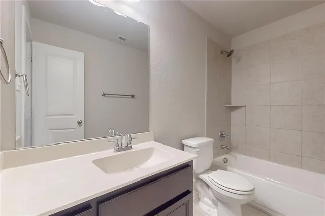 a bathroom with a sink toilet vanity and shower
