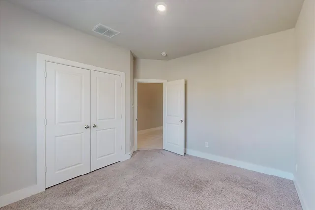 a view of an empty room and closet area