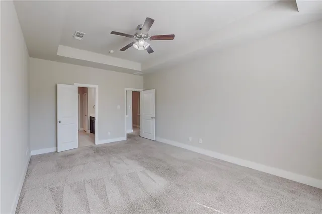 a view of an empty room with a ceiling fan