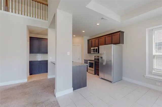 a kitchen with stainless steel appliances a refrigerator and a stove top oven