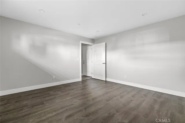 a view of wooden floor and windows in a room