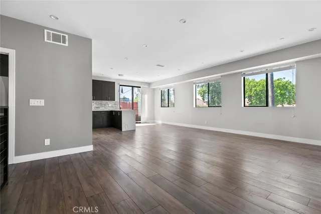 a view of a living room a window and wooden floor