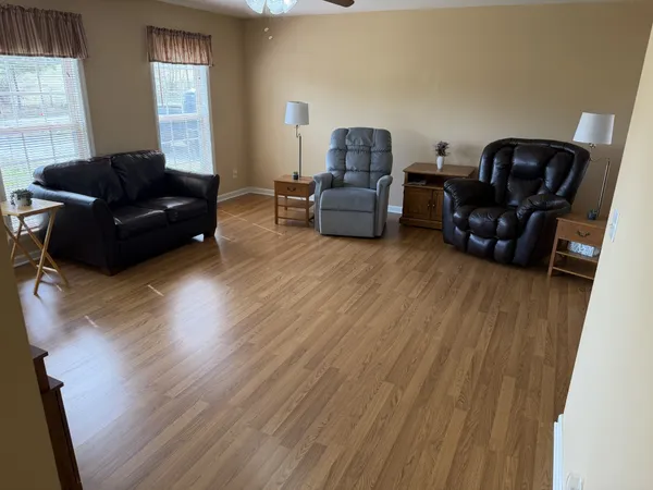 a bedroom with a bed and a flat tv screen on a dresser