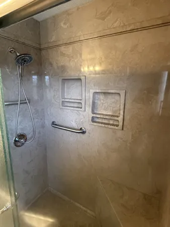 a bathroom with a sink vanity granite and a mirror