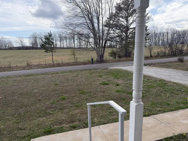 a view of a house with a car parked in front of it