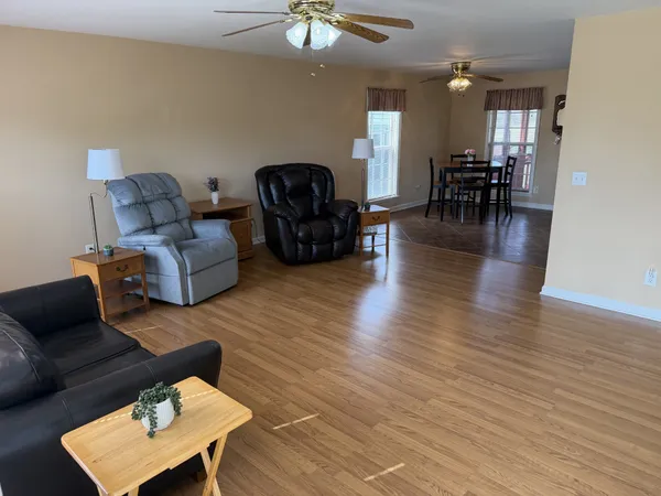 a living room with furniture and a hard wood floor