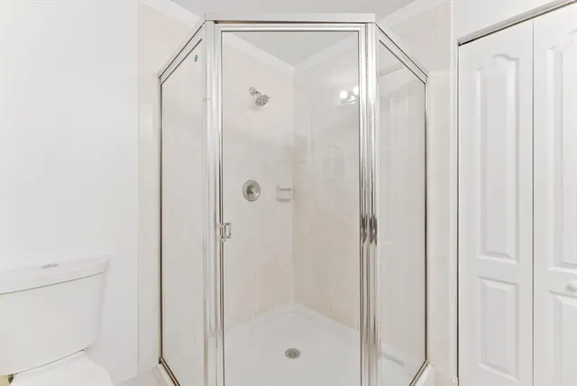 a bathroom with a glass shower door