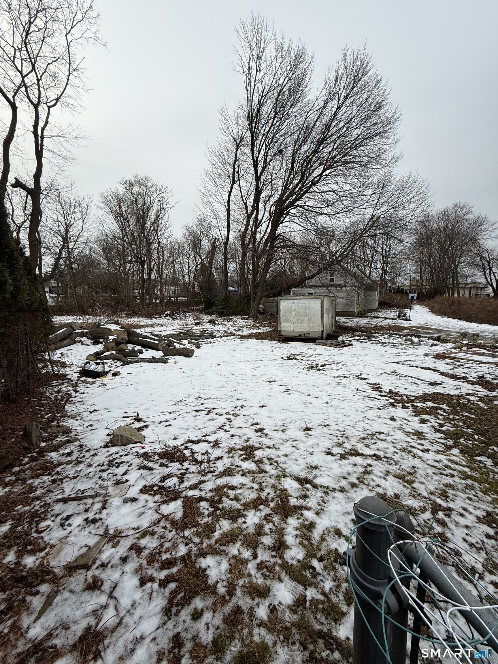 141 Poquonnock Road Groton, CT 06340 - Photo 2 of 19 a view of a yard covered in snow
