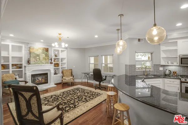 a large kitchen with a table and chairs
