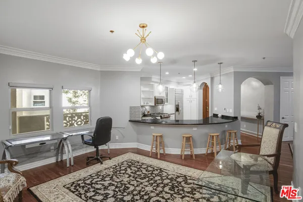 a room with lots of white furniture and a window