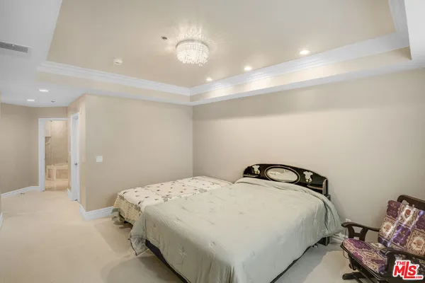 a bedroom with a bed and lamp