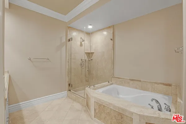 a bathroom with a tub a sink and shower