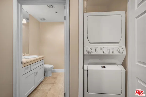 a view of bathroom with a toilet sink and mirror