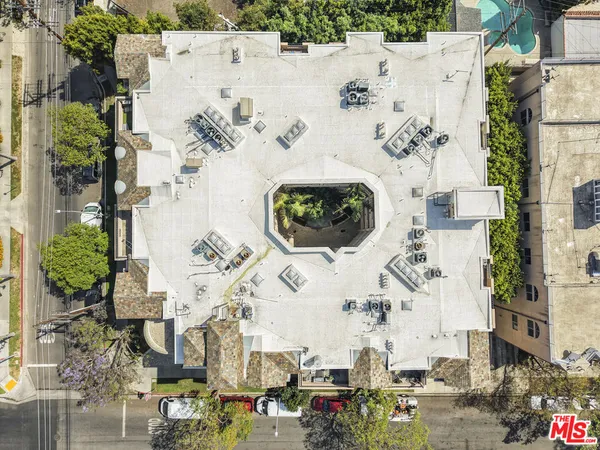 an aerial view of residential houses with outdoor space
