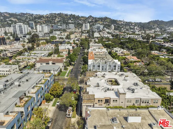 an aerial view of residential houses with city view