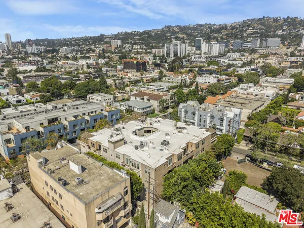 an aerial view of a residential apartment building with a city view