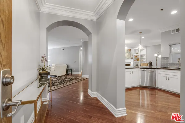 a kitchen with kitchen island a counter top space a stove a refrigerator and cabinets