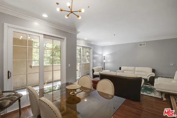 a dining room with furniture and wooden floor